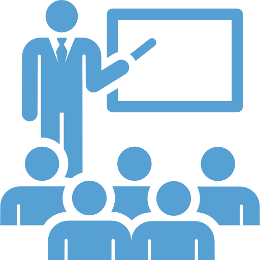 This is a Carolina Blue icon showing a teacher teaching at a blackboard in front of a class.
